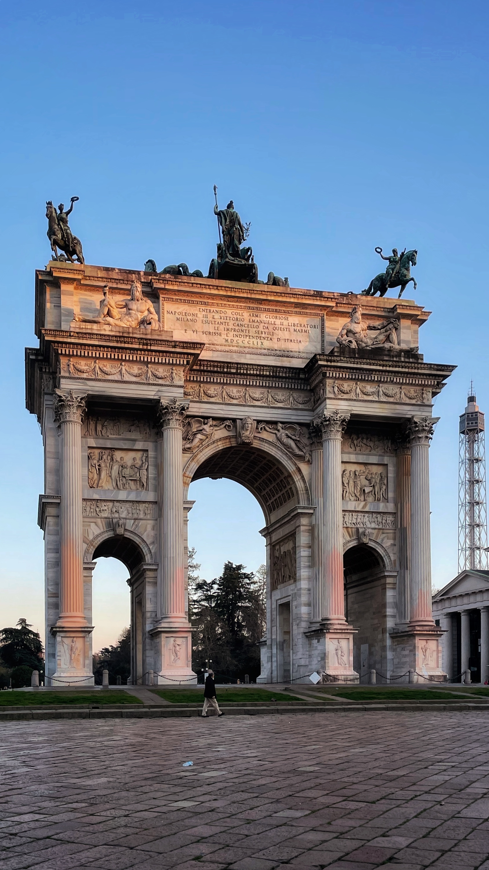 Arco della Pace at dusk, one figure crossing the empty piazza